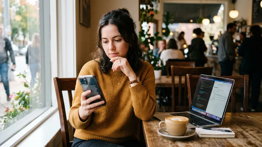 Person comparing AI assistant options on their smartphone
