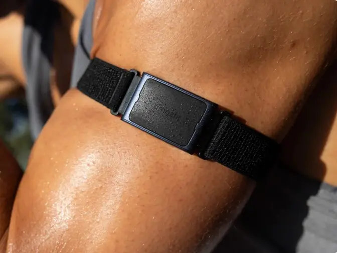 Amazfit Helio Strap fitted into a bicep band for workout tracking