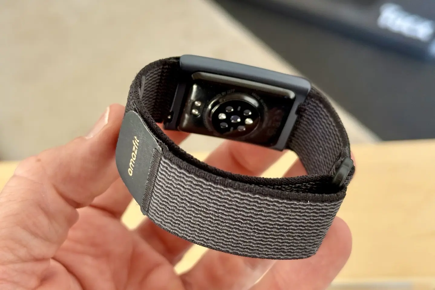 Close-up of the Amazfit Helio Strap sensor pod and heart rate array